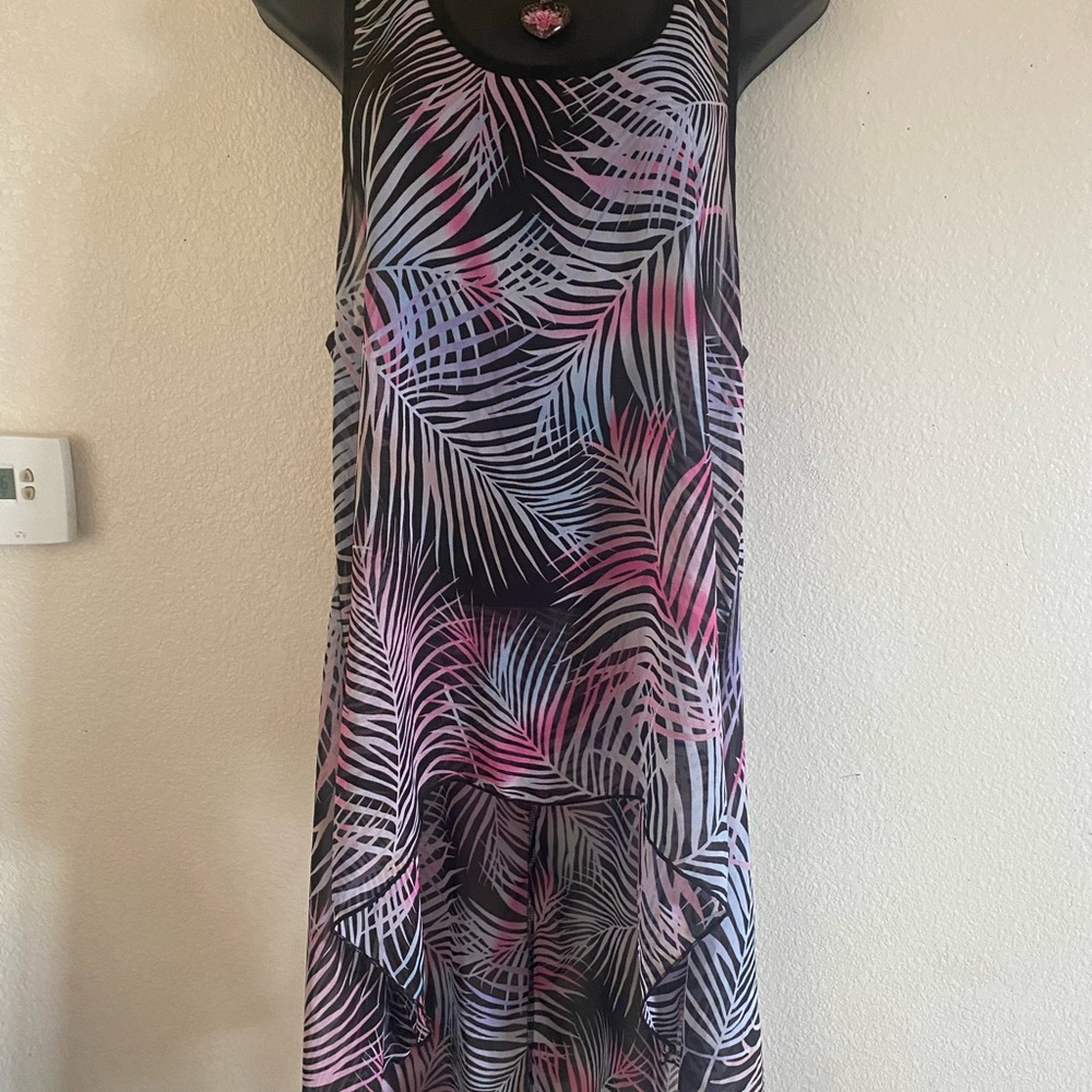 Beautiful Multi colored top . Back hangs long. Beautiful with Pink Boots.